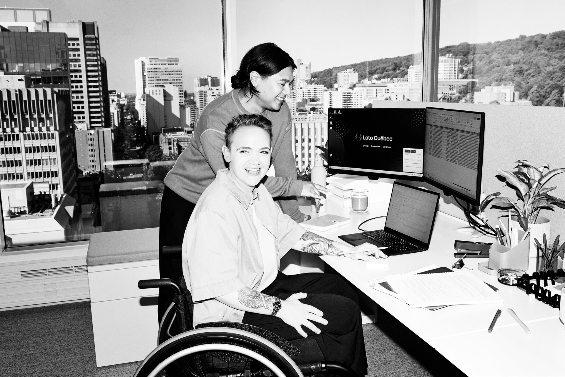 Two colleagues reviewing operations on a monitor