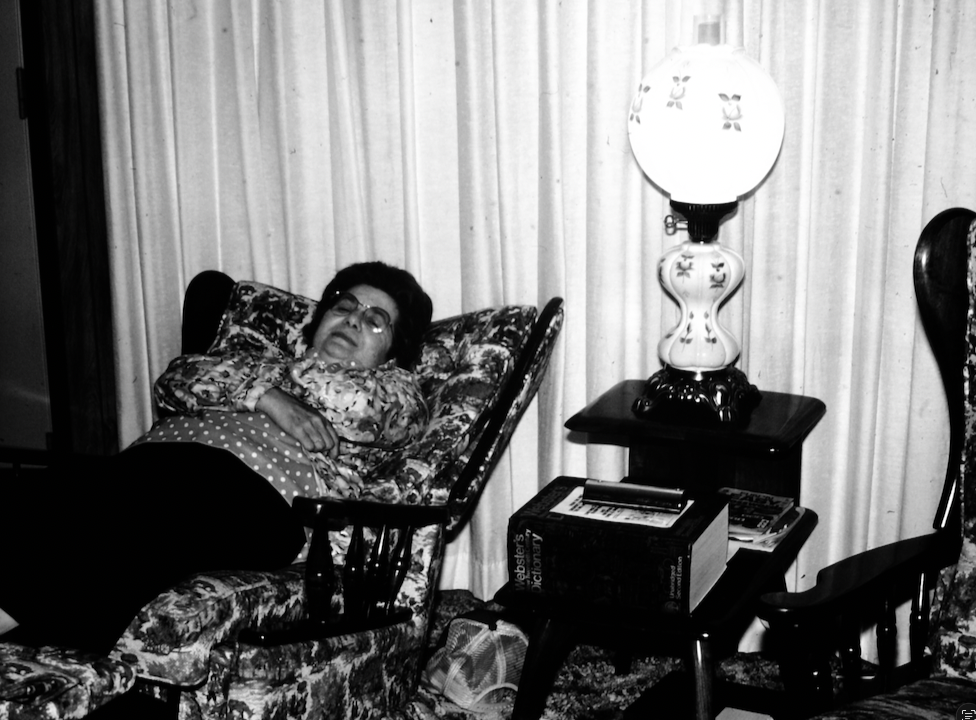 A woman resting in an armchair at home